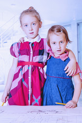 Cute little child girls  planing and blueprints in office. Humorous image.