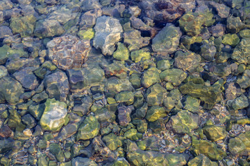 Sea stones background and light from the sun on the stones. Abstract background photo. Closeup.