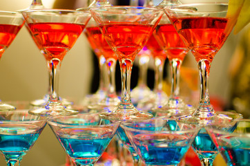 Glasses with cocktails made up in the form of a pyramid