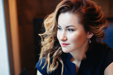 Fototapeta premium The beautiful girl in a romantic image has a rest at restaurant