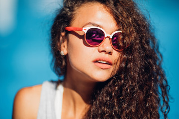Portrait of fashionable long curly dark hair lady making selfie posing beside exotic summer beach hot summer