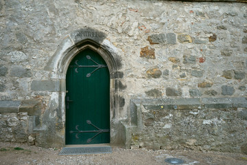 Alte grüne Seitentür an einer Kapelle