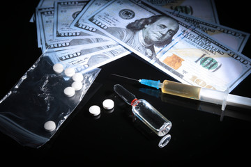 drug trafficking, crime, addiction and sale concept - closeup of with drugs and money.