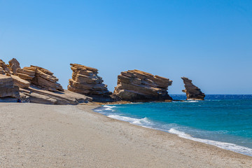 The beach of Triopetra with rocks and turquoise sea in Southern Crete, Greece. Beautiful background Mediterranean sea.