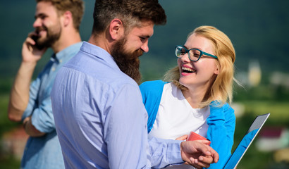 Colleagues with laptop work outdoor sunny day, nature background. Colleagues work with laptop while...
