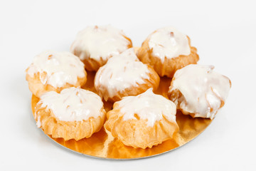 Traditional french Profiteroles, choux pastry with whipped cream inside. Group of french dessert on white background.