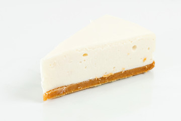 Slice of plain New York cheesecake . Sweet dessert in the restaurant. Morning light