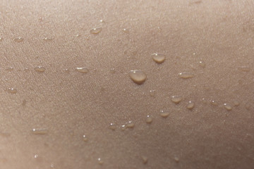 Fototapeta na wymiar Water drops on human skin macro shot