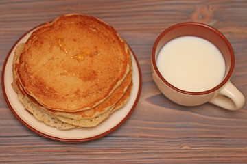  pancakes on a plate of milk and honey