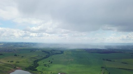 Beautiful aerial drone shot oh the fields with the city on the background