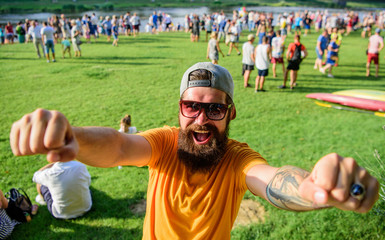Urban event celebration. Cheerful fan at summer fest. Man bearded hipster in front of crowd people...