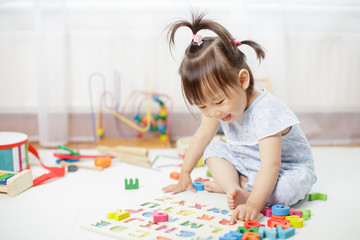 baby girl learning alphabet at home