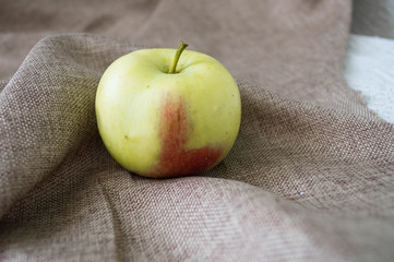 yellow apple on a beige background