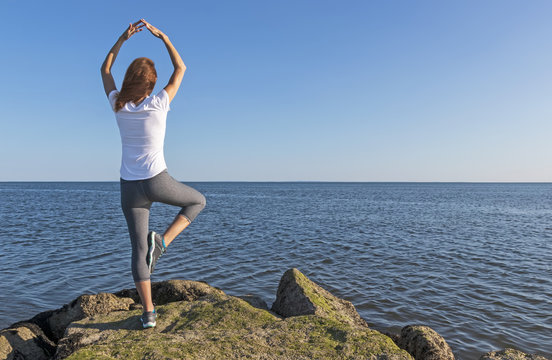 Fitness Woman Pose Overlooking Ocean