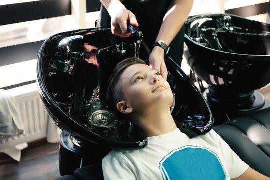 Boy get his hair washed in barder shop