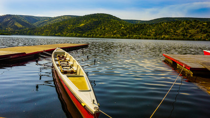beautiful forest reflections in a lake with  a boat during beautiful day at Eymir Lake Ankara, Turkey