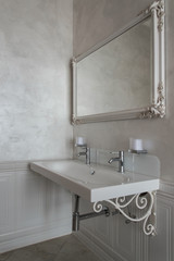 Luxury double washbasin in the bathroom with a huge mirror.