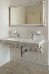 Luxury double washbasin in the bathroom with a huge mirror.