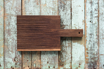 Handicraft dark oak cutting board on shabby blue background