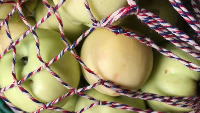 Ripe apples in a string bag. Healthy food concept.