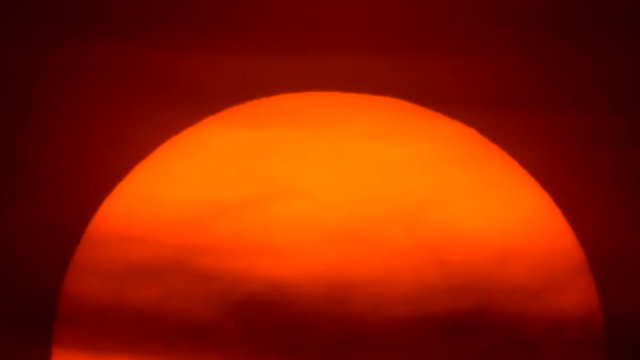 Sunset - Huge sun filling the frame moving slowly down.