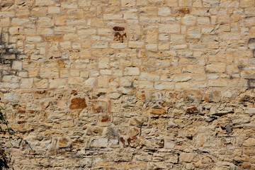 Natural background, ancient wall of the medieval city, the wall of an ancient temple in Prague, stone masonry test with cement