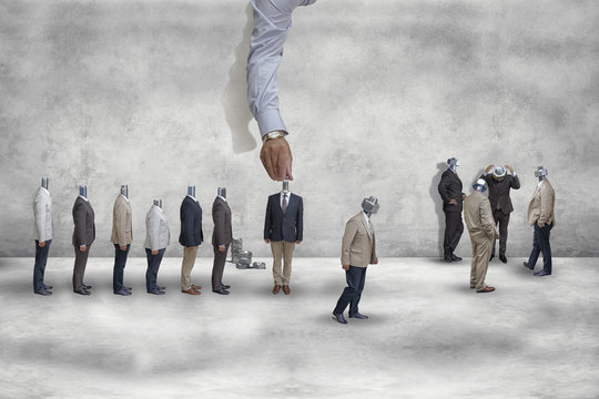 Men in business suits, with screws instead of necks. A large hand screws the nuts instead of the head