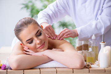 Obraz na płótnie Canvas Woman during massage session in spa