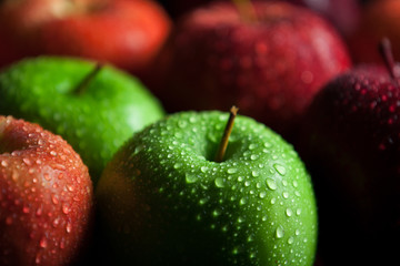 Apples with water droplets and dark shadows