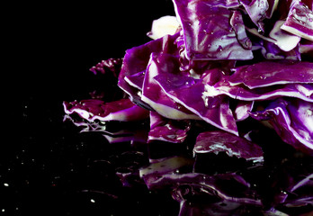 Violet slices of cabbage for salad on a black background