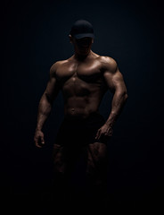Fototapeta na wymiar Muscular bodybuilder guy doing exercises