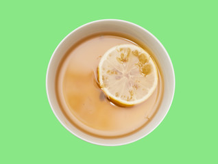 tea with lemon on a green background