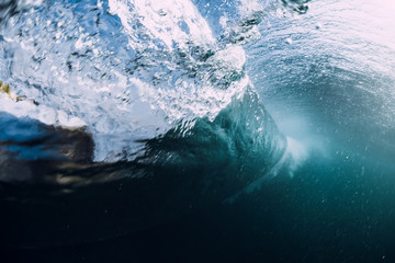 Underwater barrel wave crashing in ocean.