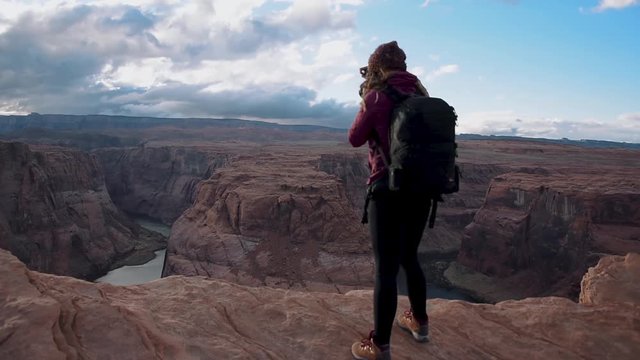 Female Photographer Taking Pictures of Grand Canyon