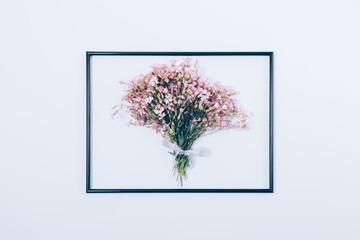 Bouquet of beautiful pink flowers in thin black frame