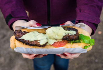 Close up photo of an open sandwich with lamb meat, rocket salad, tomato, and aioli garlic...