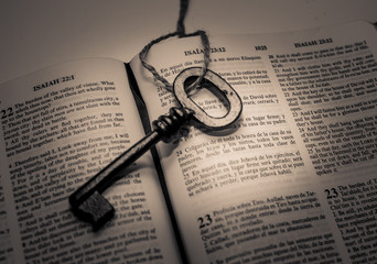 A key sitting on an open Bible