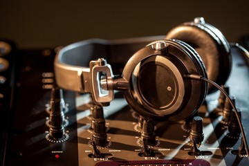 DJ headphones on top of a mixing board