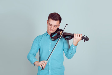 Young man playing on wooden violin