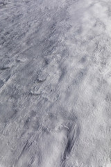 A textured pattern of the icy snow on the ground making a perfect white pattern