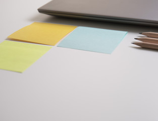 note pad paper and laptop on the white table