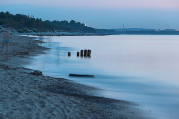 smooth sea surface and coast in blue twilight on long exposure
