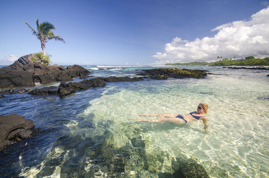 Woman swimming in tropical lagoon