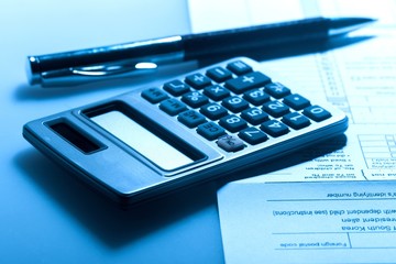 Calculator, Pen and Financial Document