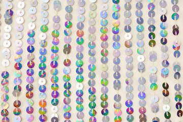 Colorful round sequins on knitting fabric for holiday backgrounds   