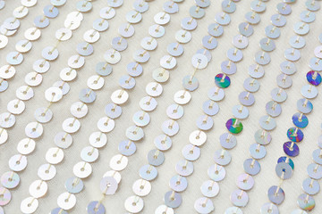 Colorful round sequins on knitting fabric for holiday backgrounds   