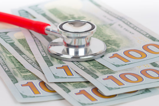 100 dollars banknotes and stethoscope, expensive medical care concept