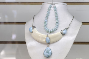 gemstone Larimar raw, carved and jewelry made in necklaces for sale as a gift for tourists and merchants in the model market of Santo Domingo