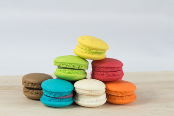 Colorful macaroon sweet desset on wood table.