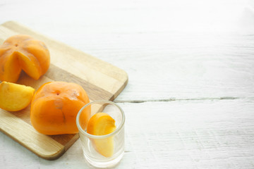 Persimmon on a white background, persimmon orange in front view